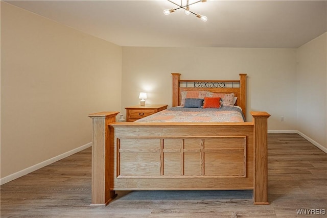 1558 Youngstown Wilson Rd, Porter, NY 14174 - bedroom with wood finished floors and a chandelier
