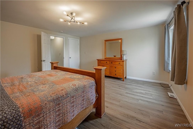 1558 Youngstown Wilson Rd, Porter, NY 14174 - bedroom with wood finished floors and a chandelier