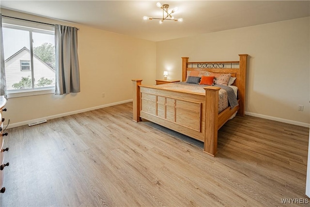 1558 Youngstown Wilson Rd, Porter, NY 14174 - bedroom with a chandelier and light wood-type flooring