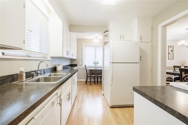 25 Kiniry Dr, Irondequoit, NY 14609 - kitchen featuring freestanding refrigerator, dark countertops, light wood finished floors, white cabinets, and a chandelier