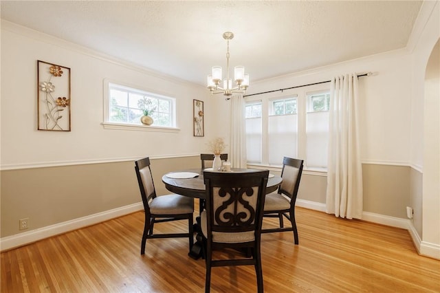 25 Kiniry Dr, Irondequoit, NY 14609 - dining room featuring light wood-style floors, a chandelier, arched walkways, and crown molding