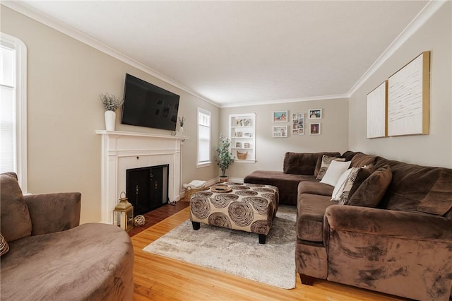 25 Kiniry Dr, Irondequoit, NY 14609 - living area with wood finished floors, ornamental molding, and a fireplace with flush hearth