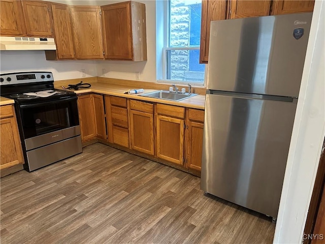 7 Rand St, German Flatts, NY 13357 - kitchen with appliances with stainless steel finishes, under cabinet range hood, light countertops, and light wood-type flooring