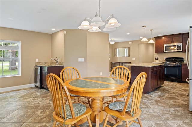 1258 State Rd, Webster, NY 14580 - dining area featuring a chandelier, recessed lighting, light stone finish floors, and bar area