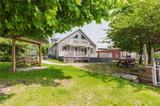 6938 Klock Rd, Lyme, NY 13693 - rear view of house with a wooden deck and a yard