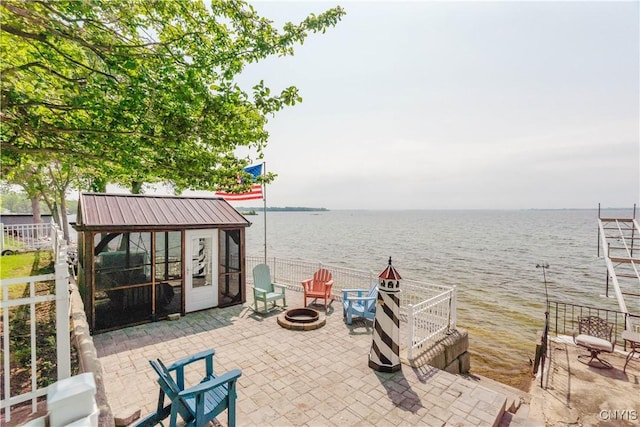 6938 Klock Rd, Lyme, NY 13693 - view of patio with a fire pit and a water view