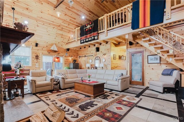 6938 Klock Rd, Lyme, NY 13693 - living room featuring wood walls, a high ceiling, wood ceiling, stairway, and tile patterned flooring