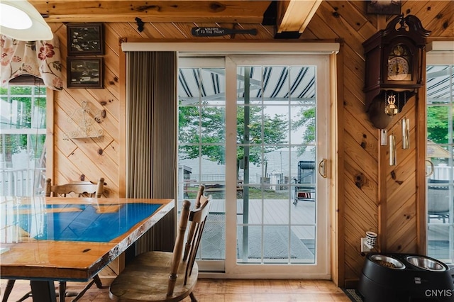 6938 Klock Rd, Lyme, NY 13693 - entryway with wood walls, plenty of natural light, light wood-style floors, and beam ceiling