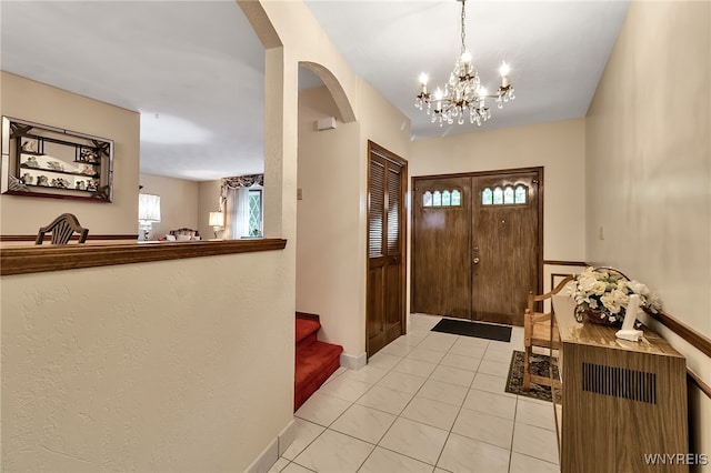 6182 Townline Rd, Wheatfield, NY 14094 - entrance foyer with a chandelier, light tile patterned flooring, arched walkways, and stairway