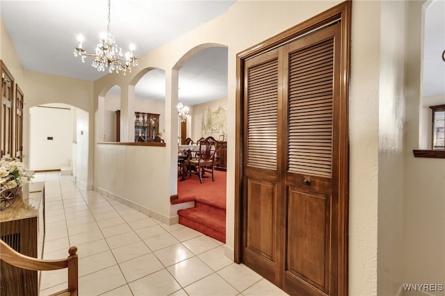 6182 Townline Rd, Wheatfield, NY 14094 - corridor with a chandelier, arched walkways, light tile patterned flooring, and light colored carpet