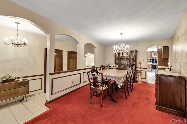 6182 Townline Rd, Wheatfield, NY 14094 - carpeted dining area featuring a chandelier and arched walkways