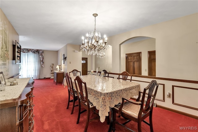6182 Townline Rd, Wheatfield, NY 14094 - dining room featuring dark carpet, a chandelier, and arched walkways