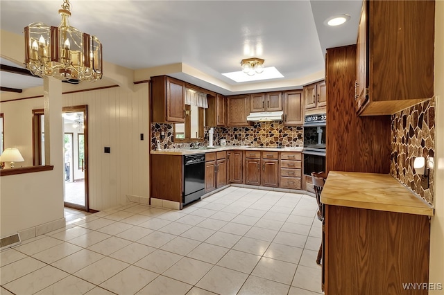 6182 Townline Rd, Wheatfield, NY 14094 - kitchen featuring black appliances, backsplash, under cabinet range hood, light tile patterned floors, and a chandelier