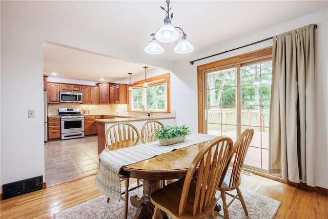 16 Clearview Dr, Henrietta, NY 14534 - dining space with light wood-style flooring and recessed lighting