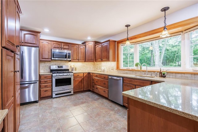 16 Clearview Dr, Henrietta, NY 14534 - kitchen with stainless steel appliances, plenty of natural light, pendant lighting, light stone countertops, and recessed lighting