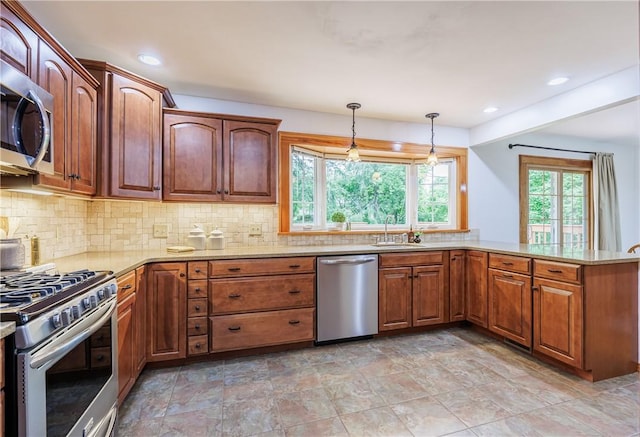 16 Clearview Dr, Henrietta, NY 14534 - kitchen featuring appliances with stainless steel finishes, tasteful backsplash, hanging light fixtures, light stone countertops, and recessed lighting