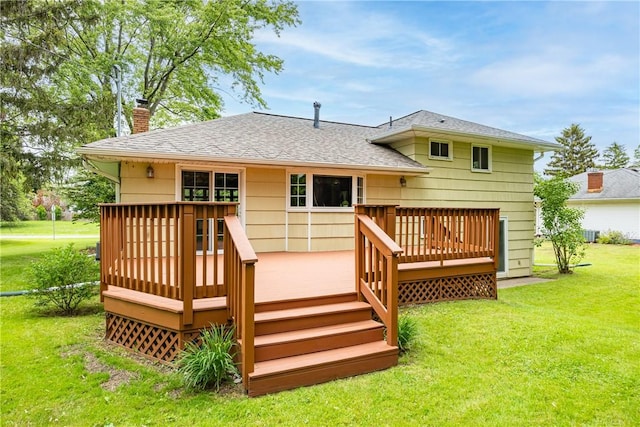 16 Clearview Dr, Henrietta, NY 14534 - back of property featuring a chimney, a yard, a wooden deck, and roof with shingles