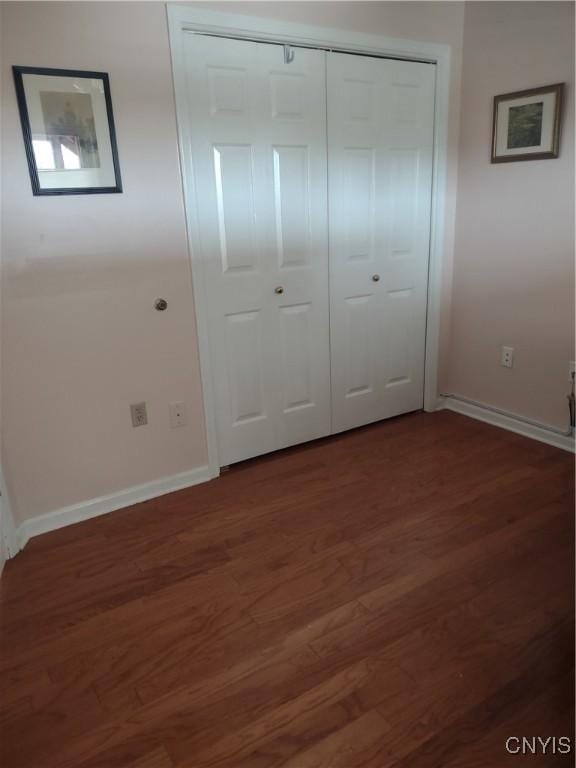 407 Fultz Dr, Oneida-Inside, NY 13421 - unfurnished bedroom featuring dark wood-style flooring and a closet