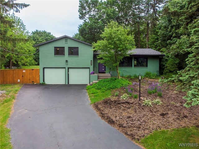 4535 Ransom Rd, Clarence, NY 14031 - view of front facade featuring a garage, asphalt driveway, and stucco siding