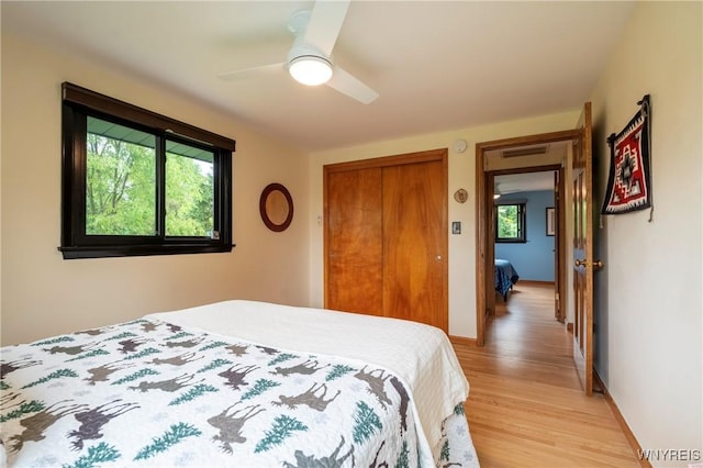 4535 Ransom Rd, Clarence, NY 14031 - bedroom with multiple windows, light wood finished floors, a closet, and ceiling fan