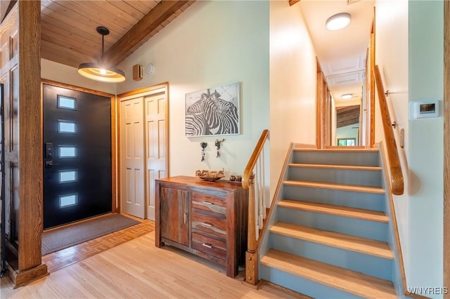 4535 Ransom Rd, Clarence, NY 14031 - entryway featuring a wood ceiling with exposed beams, parquet flooring, and stairway