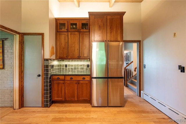 4535 Ransom Rd, Clarence, NY 14031 - kitchen featuring freestanding refrigerator, a baseboard heating unit, brown cabinetry, light wood-style flooring, and beamed ceiling