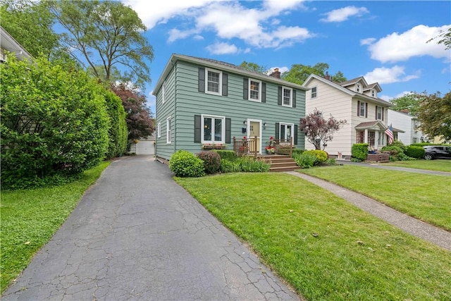 30 Northfield Rd, Irondequoit, NY 14617 - colonial home featuring a chimney, a front lawn, and a garage