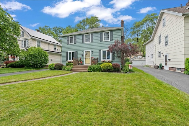 30 Northfield Rd, Irondequoit, NY 14617 - colonial home with a chimney, an outbuilding, a front lawn, and a garage