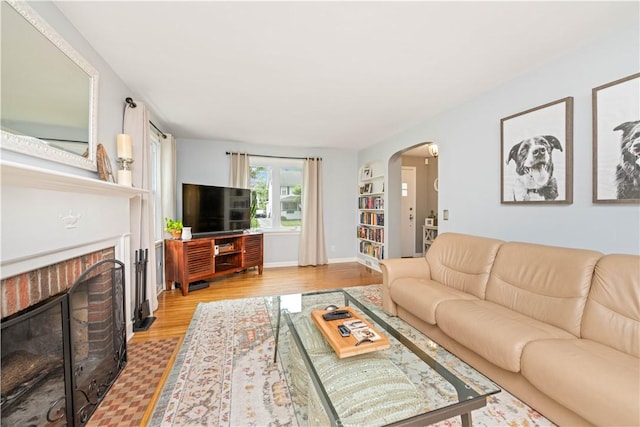 30 Northfield Rd, Irondequoit, NY 14617 - living room with arched walkways, a fireplace, and light wood finished floors
