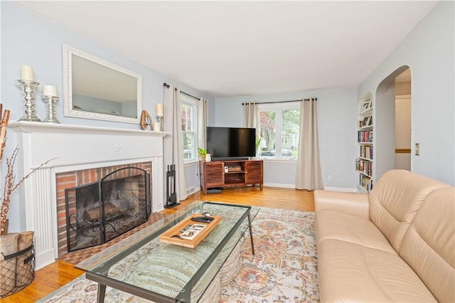 30 Northfield Rd, Irondequoit, NY 14617 - living area with wood finished floors, a brick fireplace, and arched walkways