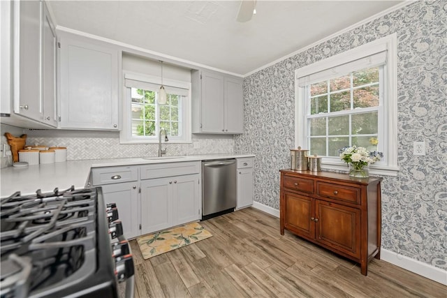 30 Northfield Rd, Irondequoit, NY 14617 - kitchen featuring appliances with stainless steel finishes, wallpapered walls, light wood-style floors, crown molding, and light countertops
