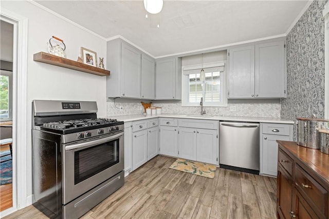 30 Northfield Rd, Irondequoit, NY 14617 - kitchen with appliances with stainless steel finishes, open shelves, light wood-style floors, healthy amount of natural light, and ornamental molding