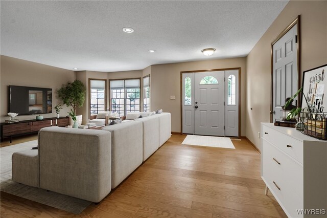 139 Autumn Creek Ct, Amherst, NY 14051 - living room featuring light wood-style floors, a textured ceiling, and recessed lighting