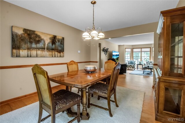 139 Autumn Creek Ct, Amherst, NY 14051 - dining room with a chandelier and light wood-type flooring