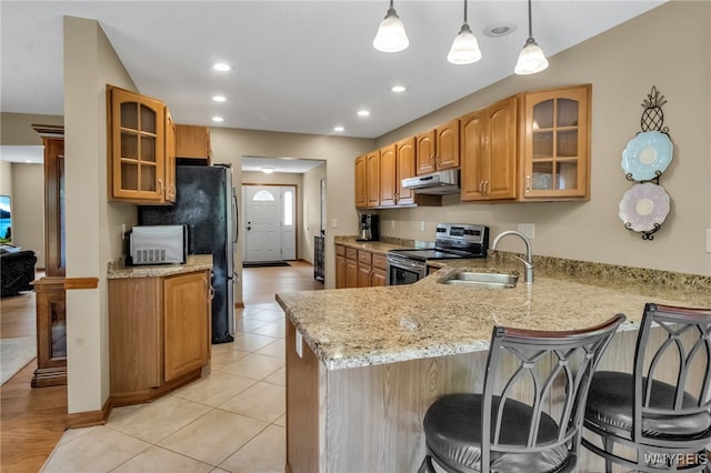 139 Autumn Creek Ct, Amherst, NY 14051 - kitchen with stainless steel appliances, under cabinet range hood, a peninsula, a breakfast bar, and light stone countertops