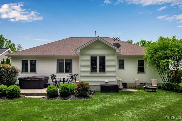 139 Autumn Creek Ct, Amherst, NY 14051 - rear view of property featuring a hot tub, an outdoor fire pit, a lawn, and a patio