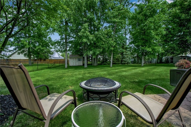 139 Autumn Creek Ct, Amherst, NY 14051 - fenced backyard featuring a fire pit and a storage unit