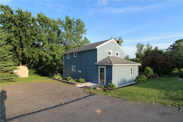 556 Middle Rd, Henrietta, NY 14467 - view of side of home featuring a lawn and roof with shingles