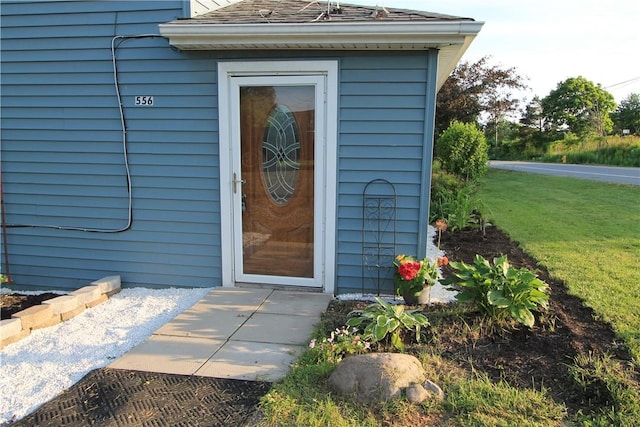 556 Middle Rd, Henrietta, NY 14467 - doorway to property featuring a shingled roof and a yard