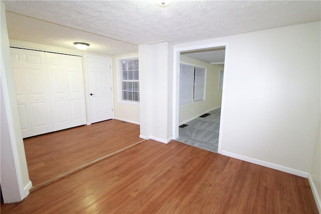 556 Middle Rd, Henrietta, NY 14467 - empty room with wood finished floors and a textured ceiling