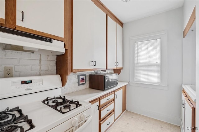 344 S Collingwood Ave, Syracuse, NY 13206 - kitchen with white gas stove, under cabinet range hood, black microwave, backsplash, and light countertops