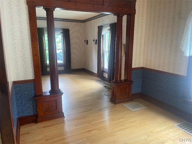 205 Morton St, Syracuse, NY 13204 - hall with ornate columns, wallpapered walls, and light wood-style floors