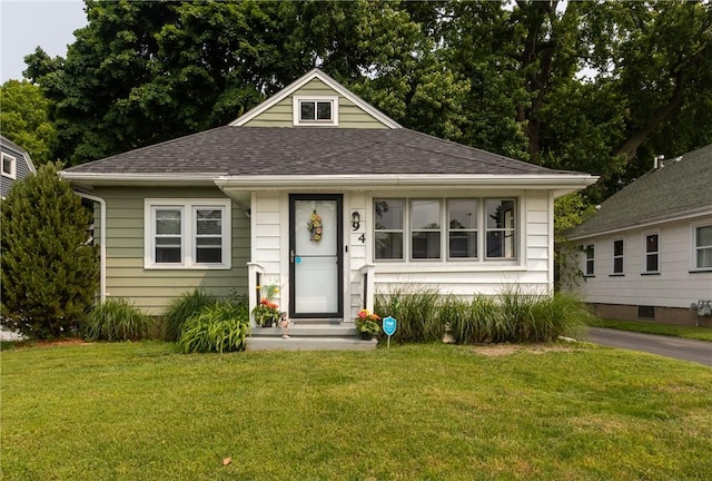 94 Birchwood Dr, Irondequoit, NY 14622 - bungalow featuring a front lawn and roof with shingles