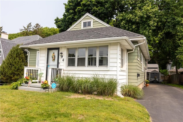 94 Birchwood Dr, Irondequoit, NY 14622 - bungalow-style home with a front lawn and a shingled roof