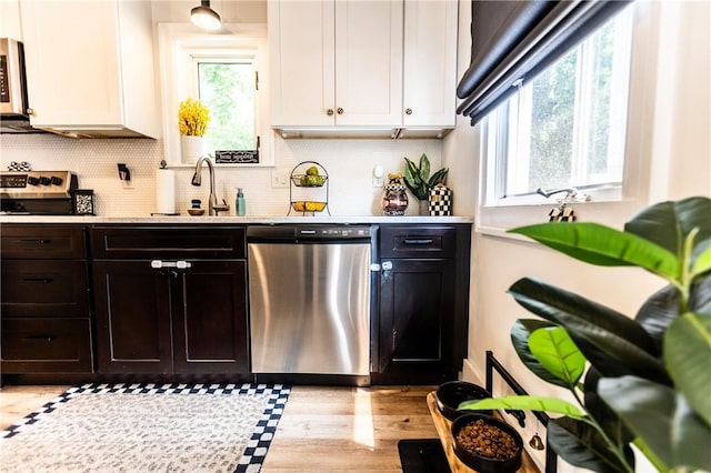 94 Birchwood Dr, Irondequoit, NY 14622 - kitchen with appliances with stainless steel finishes, plenty of natural light, white cabinets, and tasteful backsplash