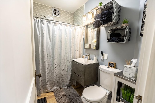 94 Birchwood Dr, Irondequoit, NY 14622 - bathroom with wood finished floors, vanity, and a shower with shower curtain
