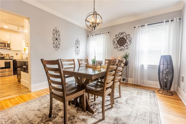 94 Birchwood Dr, Irondequoit, NY 14622 - dining room featuring a chandelier, light wood-style flooring, ornamental molding, and track lighting