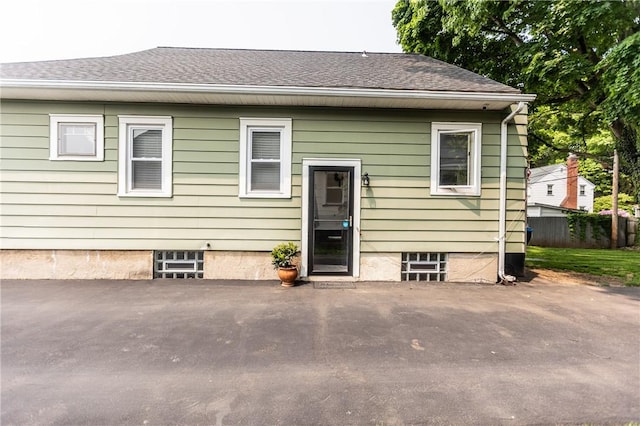 94 Birchwood Dr, Irondequoit, NY 14622 - rear view of property featuring a patio area and a shingled roof