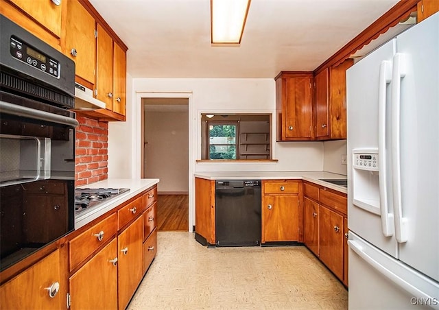 3959 Number Nine Rd, Cazenovia, NY 13035 - kitchen with black appliances, light flooring, brown cabinets, and light countertops