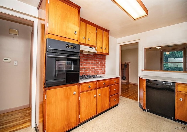 3959 Number Nine Rd, Cazenovia, NY 13035 - kitchen with black appliances, brown cabinetry, light floors, light countertops, and backsplash